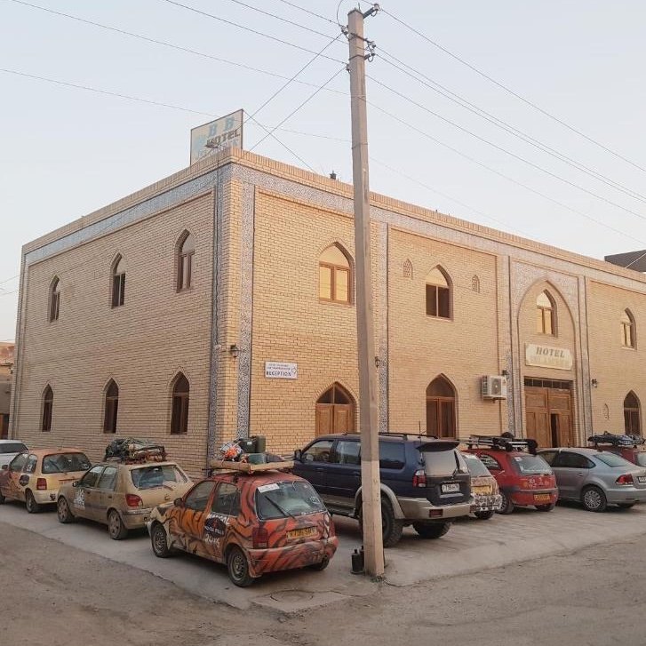 Hotel exterior with private parking area and entrance